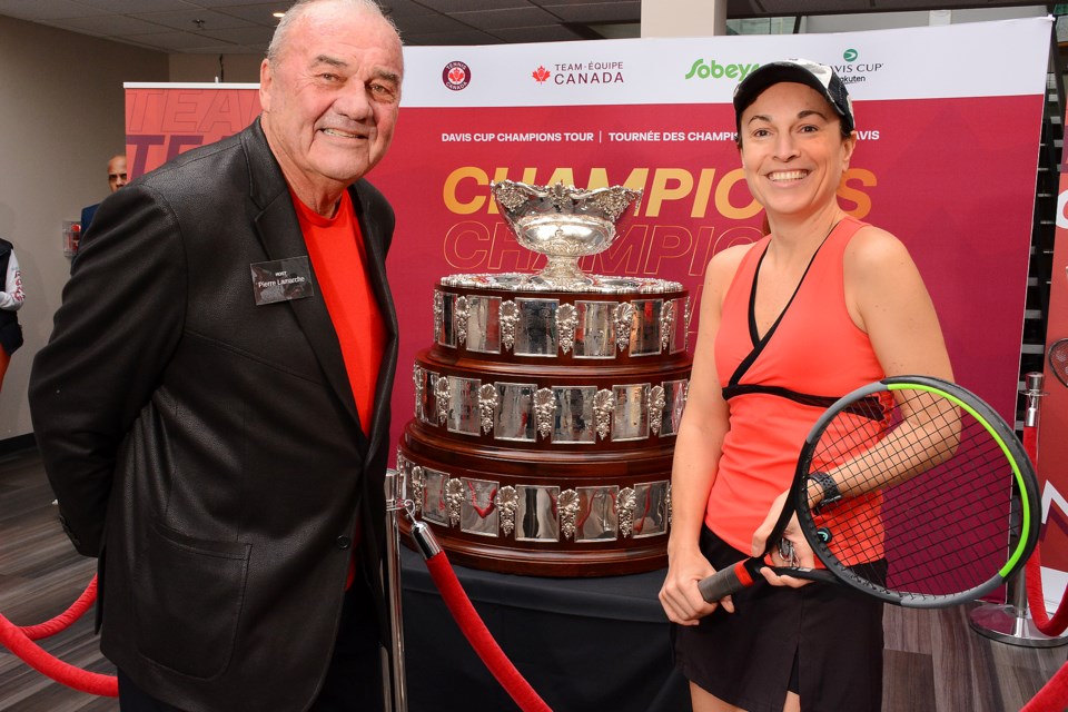 Pierre Lamarche and Cedar Springs Racquet Club member Claudia Hargrave pose with the Davis Cup in Burlington March 24. 