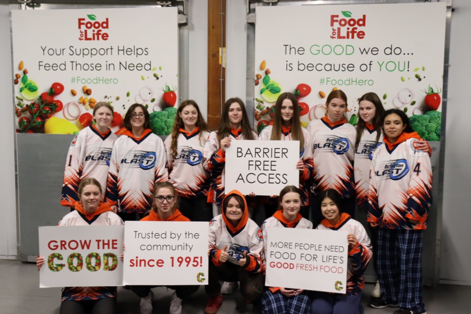 Burlington Blast U16AA players gather for a group photo after their volunteer shift at Food for Life's Mountainside Road facility March 8. The team took silver at provincials, earning them a shot at the national championship in Regina in April.