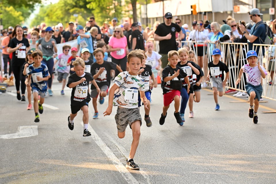 Runners pick up the pace in the kids' run at Moon in June Saturday evening.