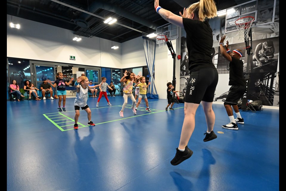 Joanna and Michael La-Rose lead youngsters through basketball drills during a recent session at Decathlon at Mapleview Centre.