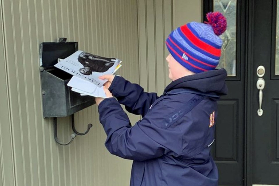Cole Fegan of the Burlington Eagles picks up the mail for his neighbours, one of many good deeds generated by the team as they pursue a Chevrolet Good Deeds Cup win.
