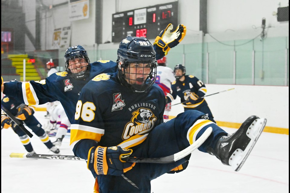 Tom Karmiris celebrates the tying goal in the first period against Oakville Friday night.
