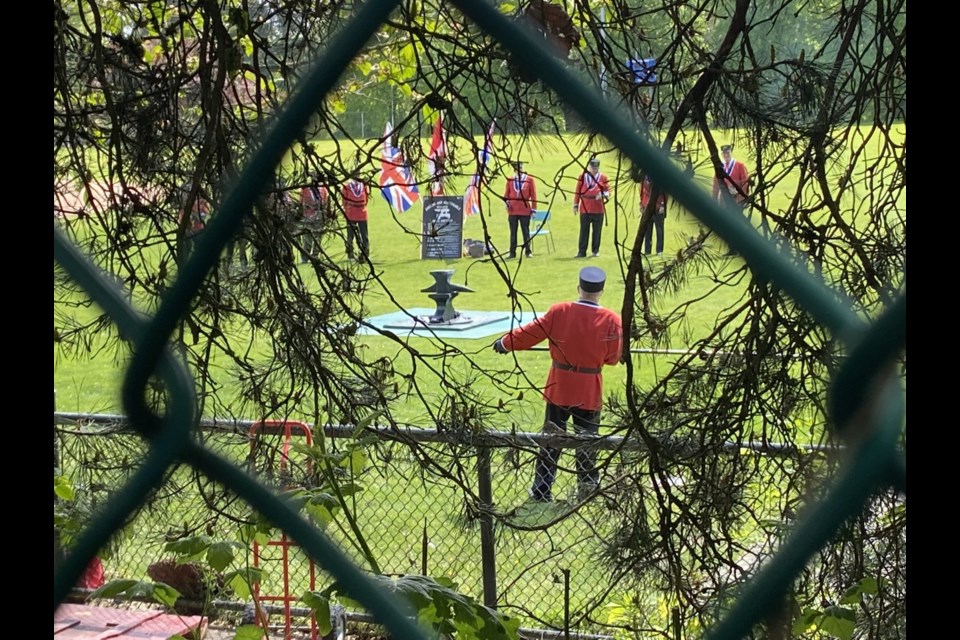 The Ancient and Honourable Hyack Anvil Battery fired a 21-anvil salute on Victoria Day in Queen's Park Stadium. The stadium was closed to the public, so folks watched from outside the fence.