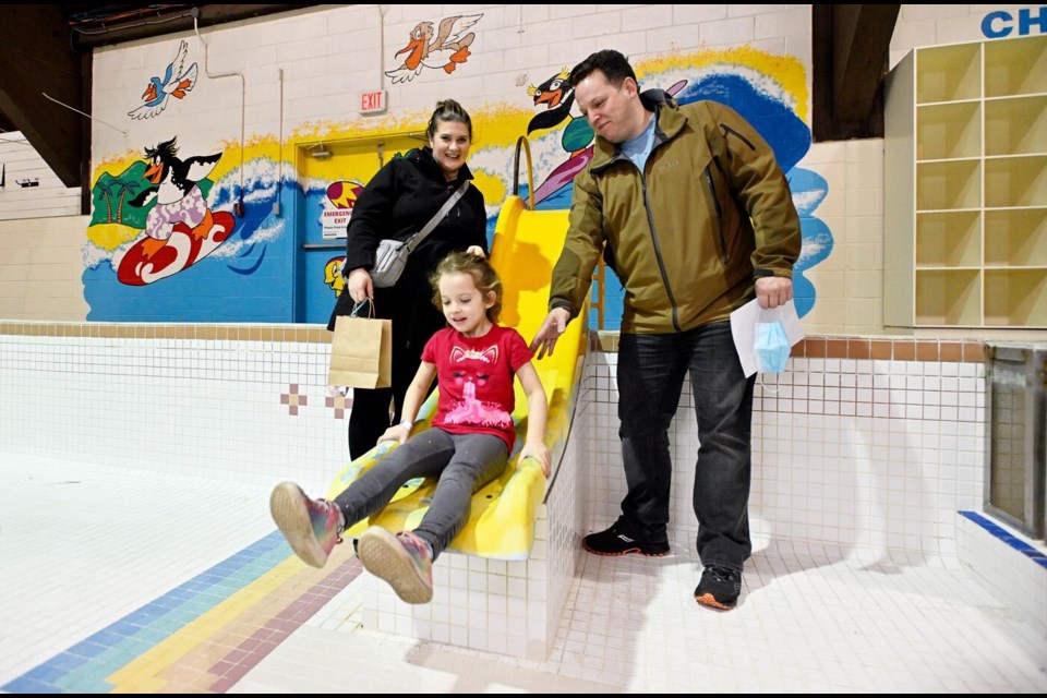 Hannah Goudreau, 5, slides in a drained pool as residents took one last look at Canada Games Pool before it is decommissioned.