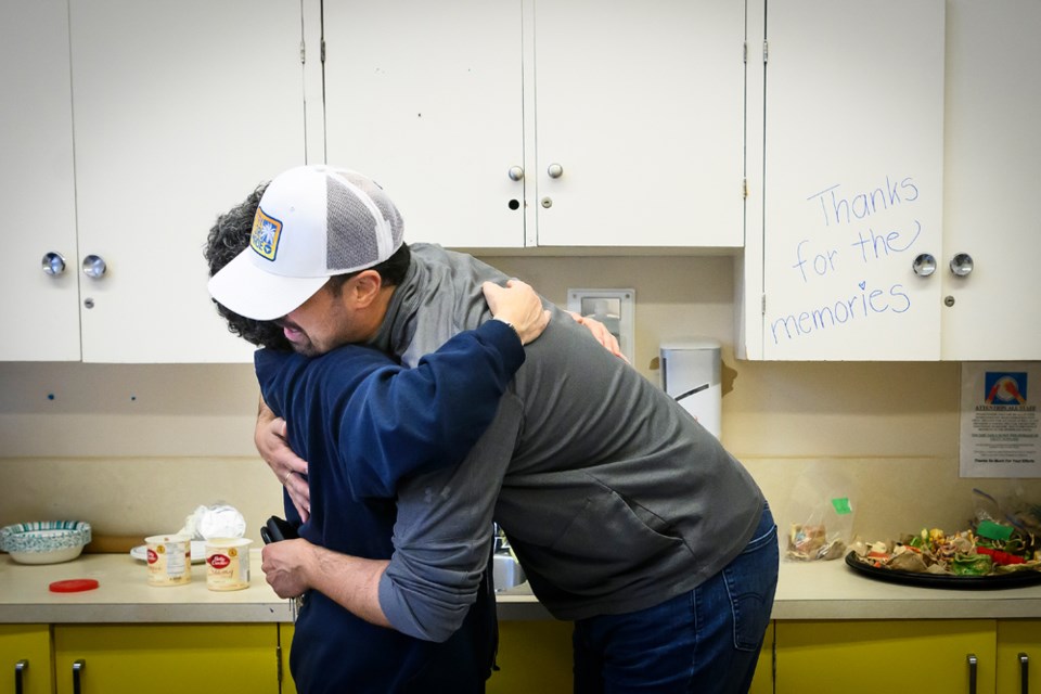 Thomas Locatelli embraces staffer Tracy Matheson at Sunday's farewell to Centennial Community Centre event.