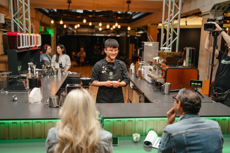 Holly Kang stands before the judges at the Starbucks North America Barista Championships.