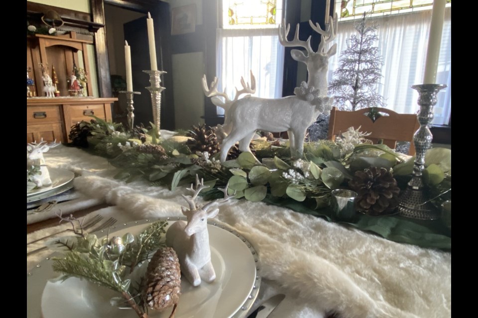 Greens and reindeer are featured in the dining room decor of a 1911 house - one of six homes featured on this year's Home for the Holidays tour.