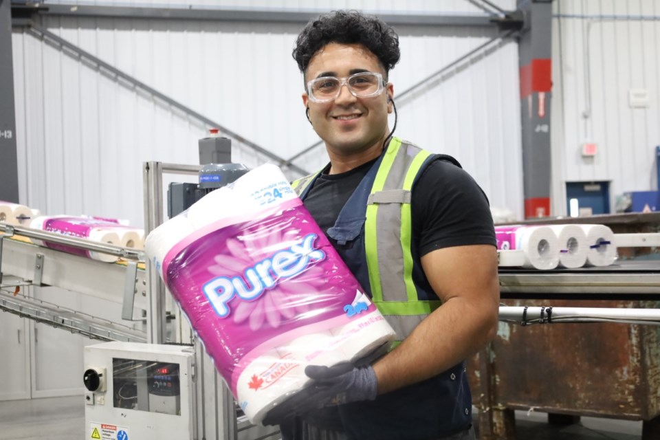 Kasra Rayani proudly displays a package of Purex that's freshly rolled off the production line at Kruger Products in New West.