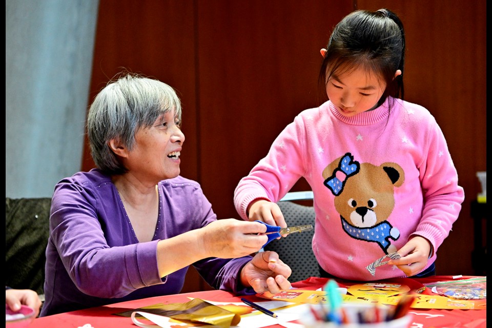 Seven-year-old Alice Wang of Burnaby works on a sky lantern with her grandmother, Lucy Wu. They were among the folks who attended a Jan. 15 workshop at Anvil Centre, part of the city’s Lunar New Year celebrations.
