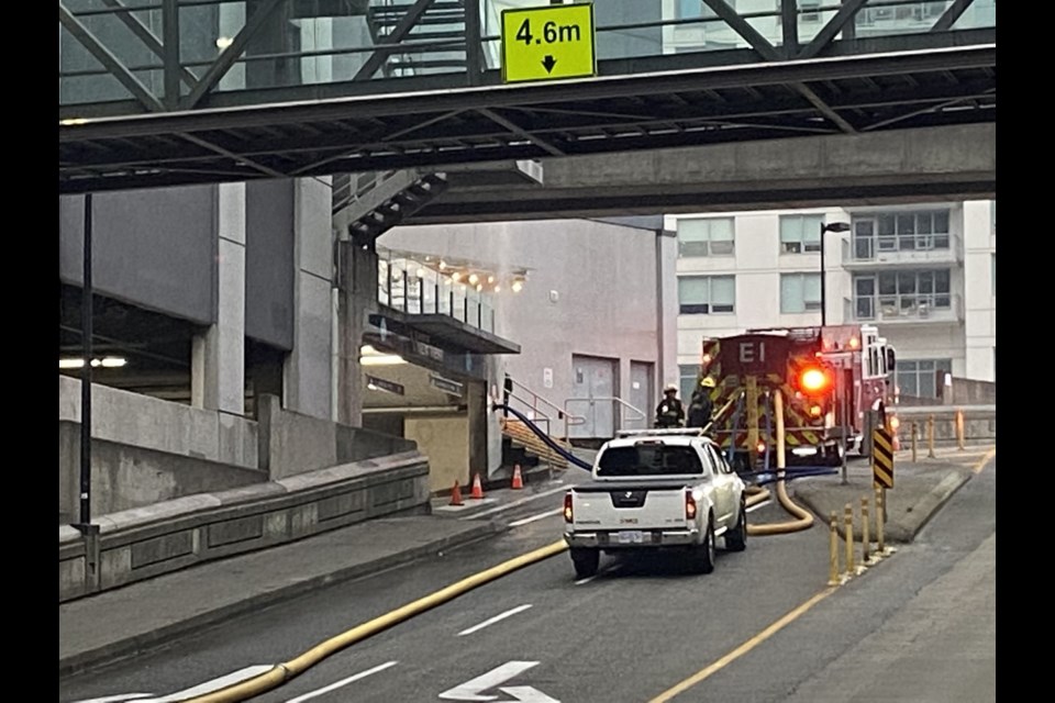 Fire trucks parked on the McInnes overpass while crews extinguished a fire at the Shops at New West on Oct. 20.