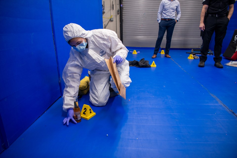 A student in the youth police academy gathers evidence.