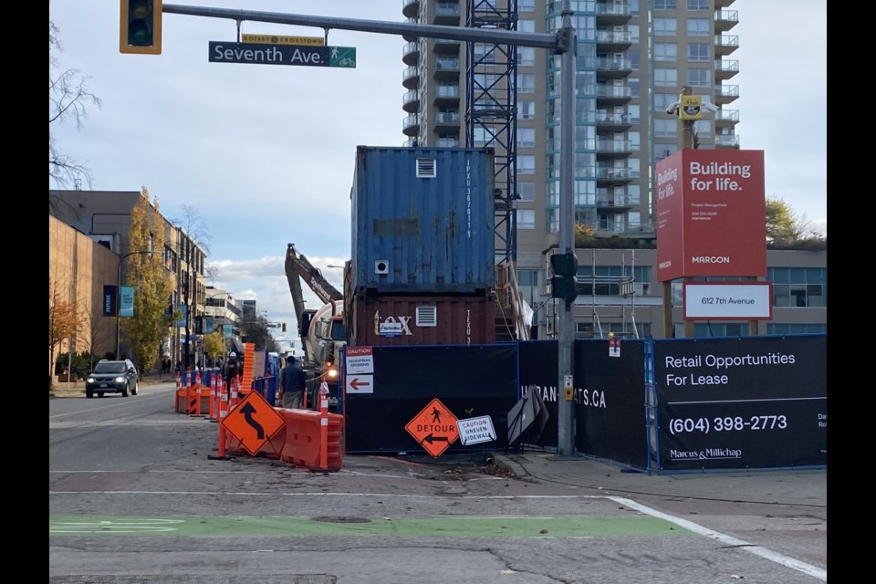 Construction vehicles are accessing a site in the uptown via Sixth Street.