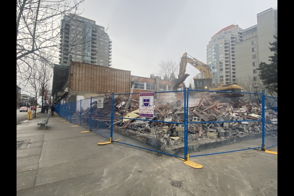 A pile of rubble gets cleared from an uptown site, where existing buildings are being demolished. 