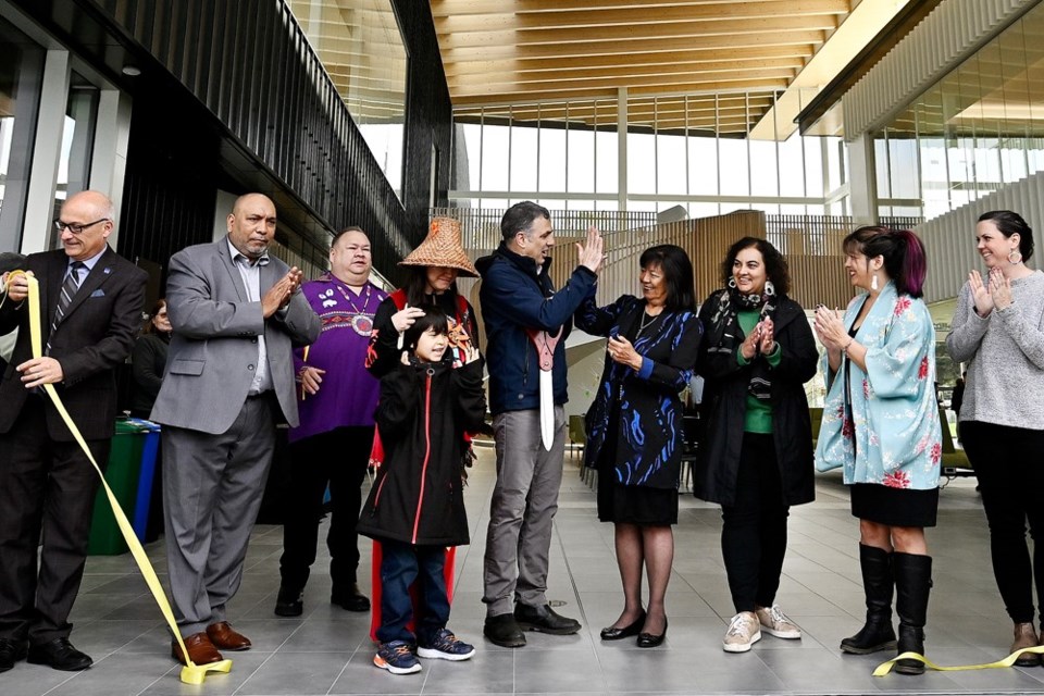 Mayor Patrick Johnstone and Qayqayt Chief Rhonda Larrabee give each other a high-five at the ribbon-cutting to mark the opening of  təməsew̓txʷ Aquatic and Community Centre on April 29.