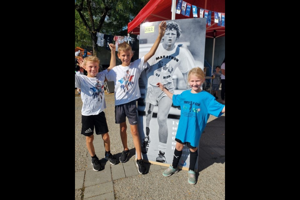 Mathew and Lucas Tully, who were the first- and second-place finishers, in the Terry Fox Run were joined by their sister Sarah, who came to run a loop after her soccer game.