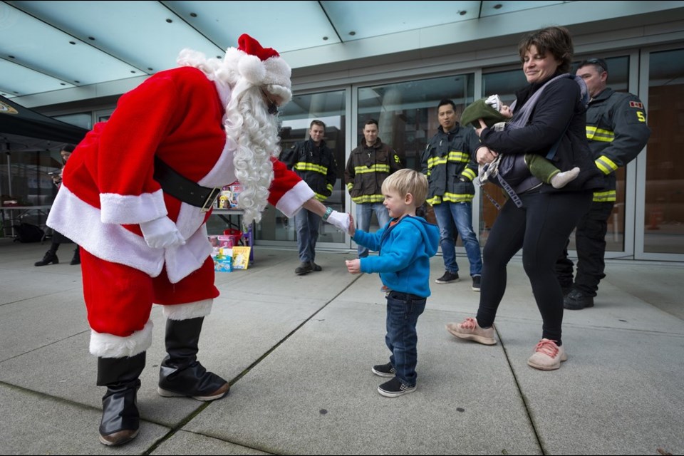 Santa Claus greeted a youngster at a toy drive at Anvil Centre on the weekend. New Westminster Burnaby MP Peter Julian and the New Westminster Firefighters' Charitable Society teamed up to host the event.