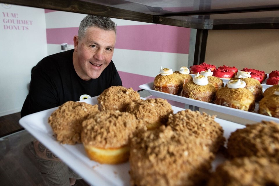 John McMahon is a co-owner of YUM Gourmet Donuts, which drew crowds during its grand opening in Sapperton on the weekend.