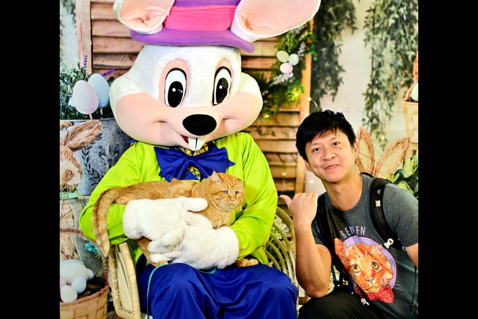 April 16, 2022. 
Albert Teng of Burnaby and BenBen the cat pose for a photo with the Easter Bunny at the Queensborough Community Centre during a fundraiser for the New Westminster Animal Shelter.
Photo: Jennifer Gauthier

