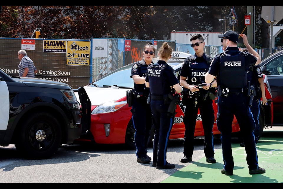 New Westminster police officers begin the process of determining what happened after an incident involving a Royal City Taxi car, which was boxed in by police vehicles at the corner of Sixth Street and Seventh Avenue Wednesday afternoon (May 17).