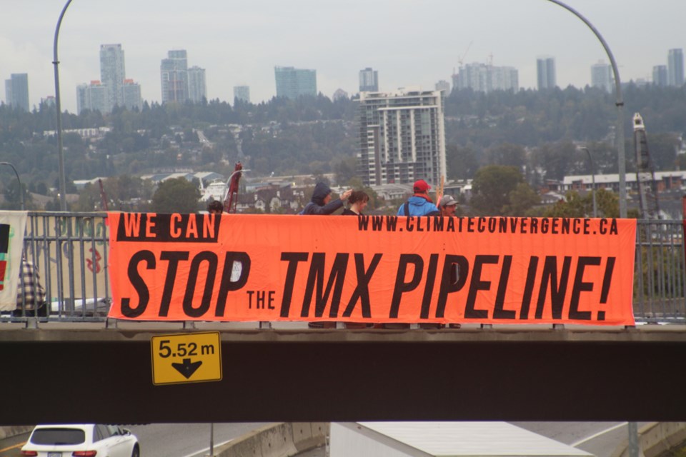 A giant Stop TMX Pipeline banner greets rush-hour traffic on Stewardson Way during the Wednesday afternoon commute.