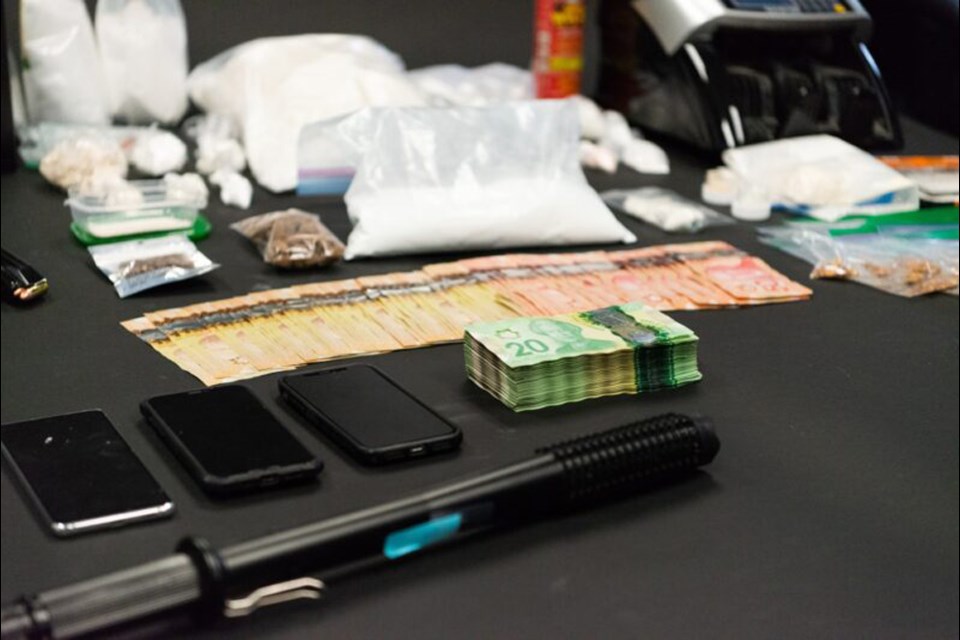 This NWPD photo shows some of the cash, drugs and other items seized as part of a drug trafficking investigation in New Westminster.