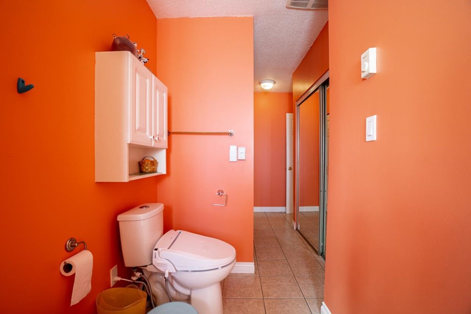 A house on 13th Avenue in Burnaby just sold and it had an outrageous glow-in-the-dark orange bathroom featured in the listing photos.