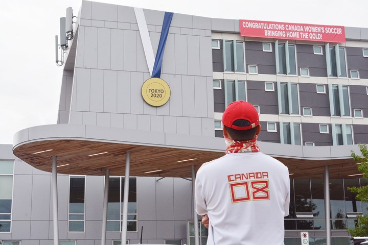 An onlooker eyes a giant medal hung in honour of Christine Sinclair.