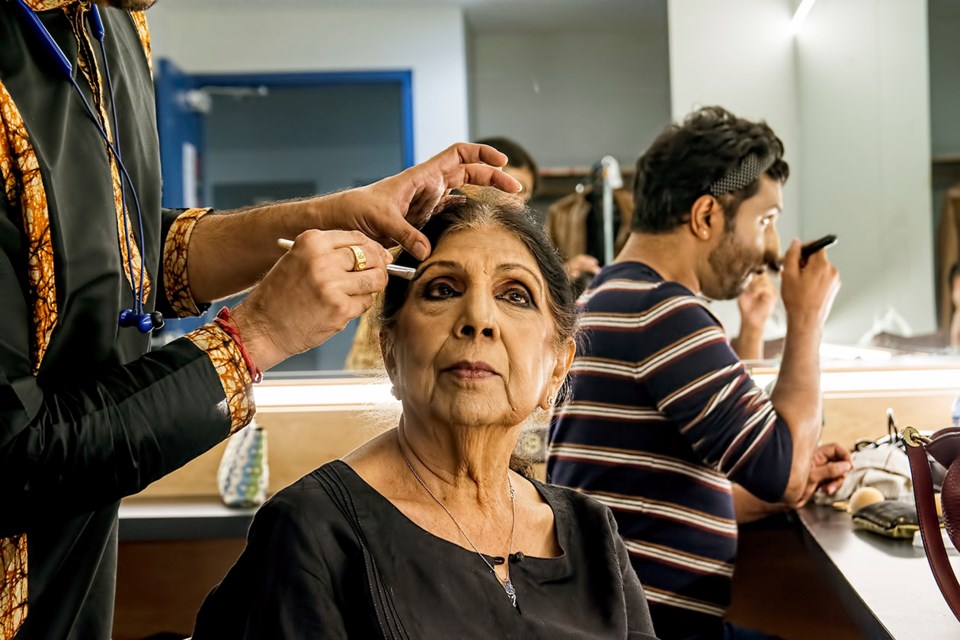 Koji - Kathak Dance with Live Orchestra at Burnaby's Michael J Fox Theatre on Aug. 20, 2023. Kathak is an ancient Indian dance form that tells story with hand gestures, footwork and expression through movement. Artistic director and storyteller Usha Gupta gets her makeup done by dancer Sauvik Chakraborty in the dressing room.
Fellow dancer Ayan Banerjee is putting on his makeup in background.