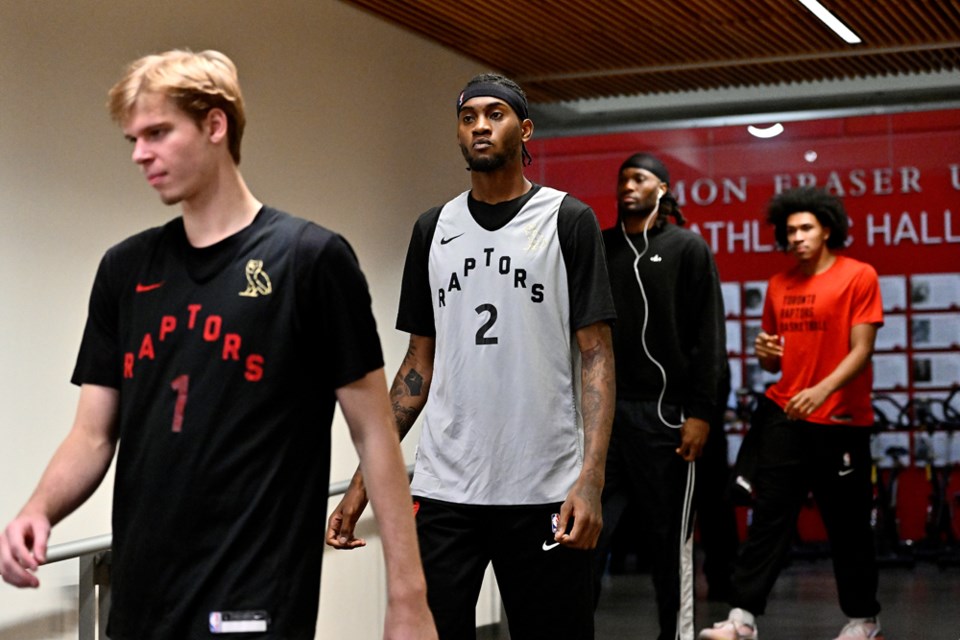 Gradey Dick and Jalen McDaniels lead the team into SFU's West gym.