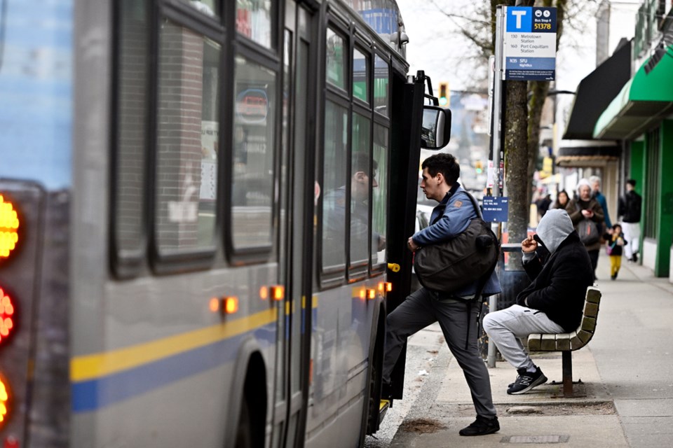 A transit users boards a bus on Hastings Street on Feb. 17, 2023. 