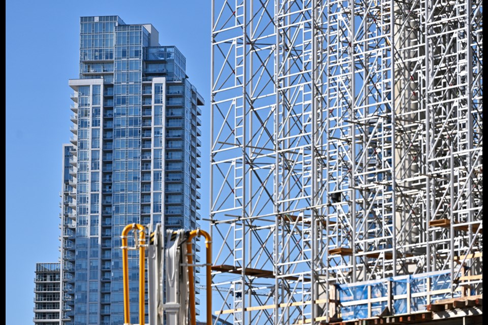 A tower in Metrotown is framed by construction scaffolding on Oct. 12, 2024.