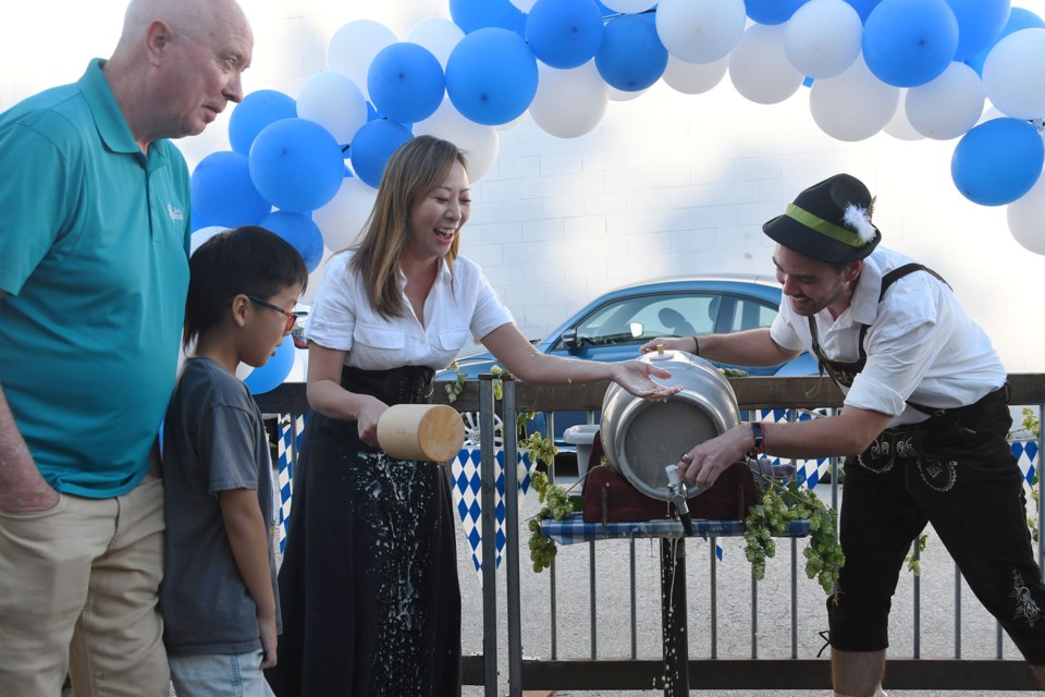 Burnaby MLA Katrina Chen taps the cask and gets sprayed with beer at Dageraad Brewing's Oktoberfest celebrations. 