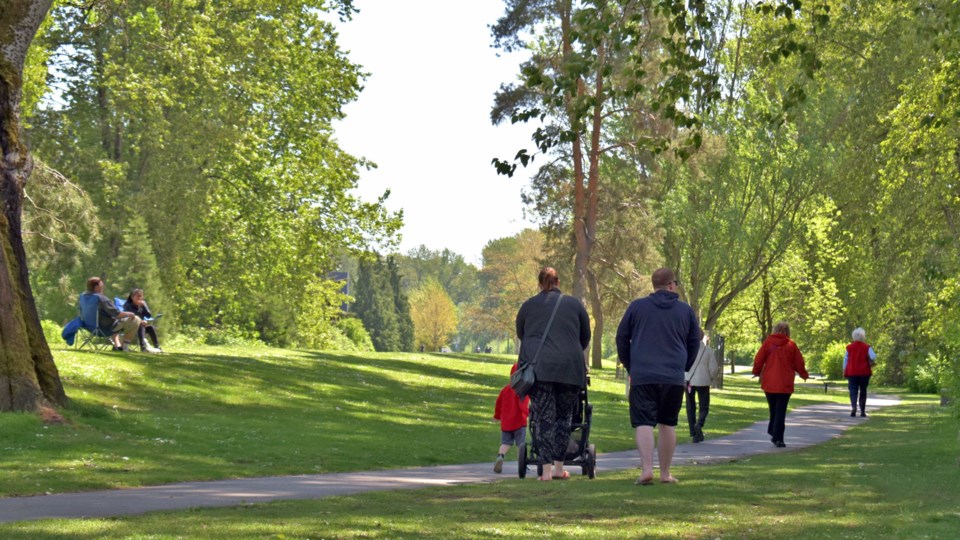 people-walk-through-fraser-foreshore-park-in-burnaby