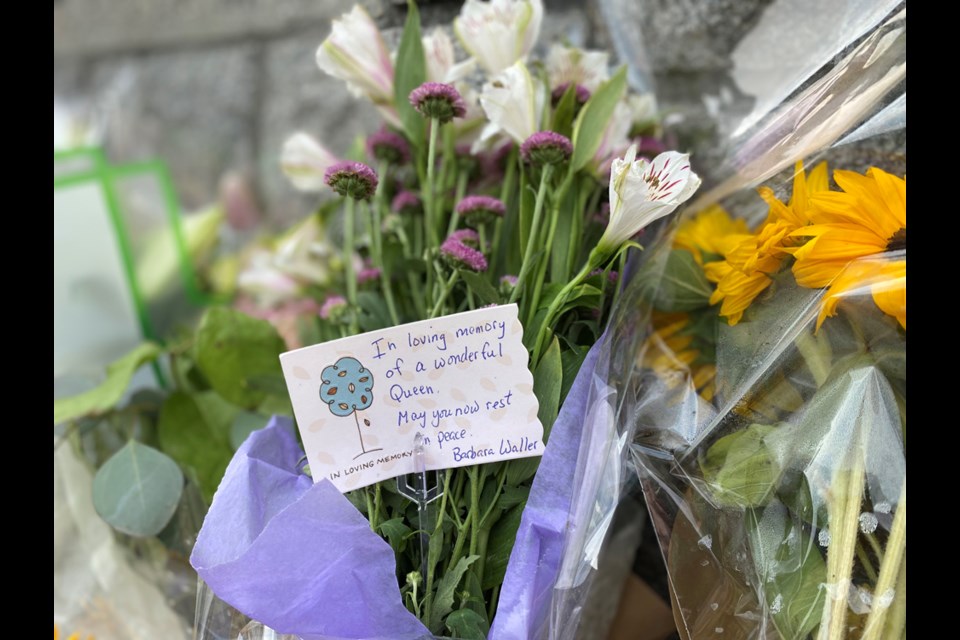 New Westminster residents are leaving handwritten messages and cards, along with flowers, at a memorial at the entrance to Queen's Park.