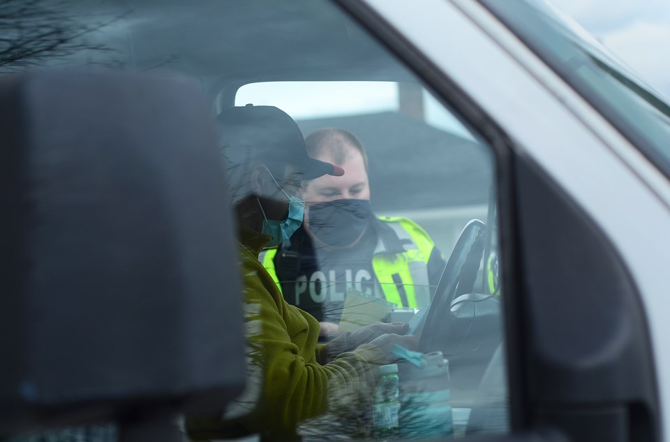 Burnaby RCMP Const. Kevin Connolly talks to a driver whose truck just failed a safety inspection on Cariboo Road near 10th Avenue Thursday.