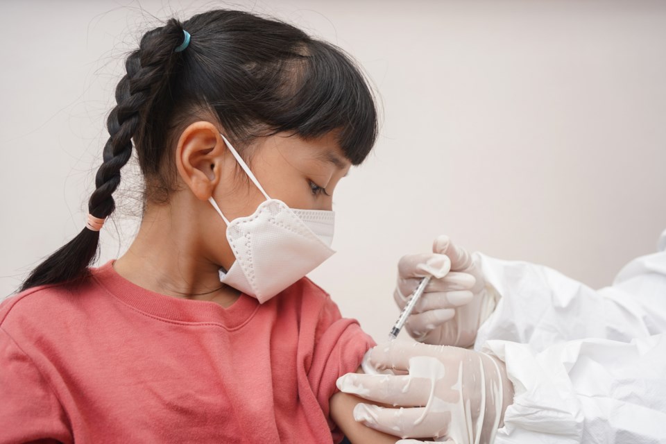 Child receiving COVID vaccine