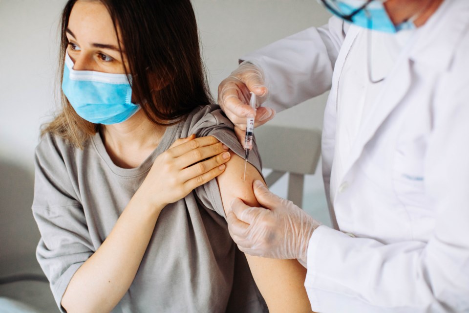 Young woman receiving COVID vaccine