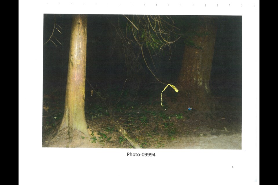 A police crime scene photo shows police tape marking the location of a wallet and cell phone belonging to a 13-year-old girl found dead in Burnaby's Central Park on July 19, 2017.