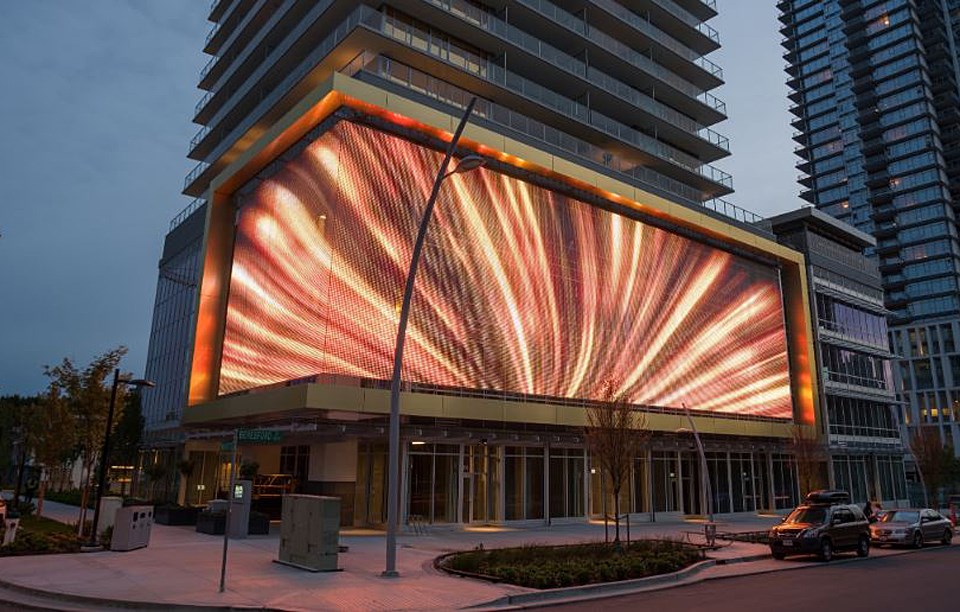 This mesh LED screen on the side of a Metrotown condo tower in Burnaby has sparked a legal battle.