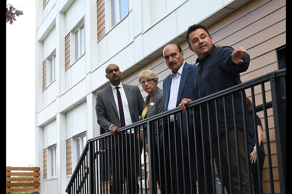 Housing Minister Ravi Kahlon, MLA Janet Routledge, MLA Raj Chouhan and Progressive Housing program manager Mauricio Reyes Gomez discuss the new supportive housing building in Burnaby.
