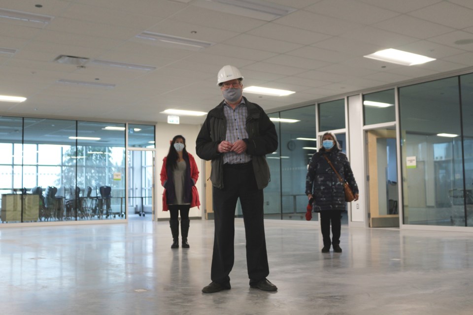 Classrooms are arranged around “campfire commons” spaces, with glass walls looking out to the central area. Here, facilities director Dave Crowe stands in one of the commons spaces. Flexible, reconfigurable furniture will also be placed in the open areas.