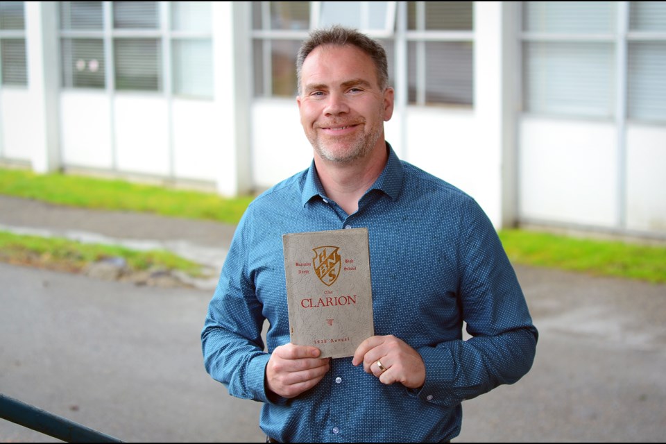 Burnaby North Secondary School principal Dave Rawnsley holds a 1936 yearbook recently donated to the school.