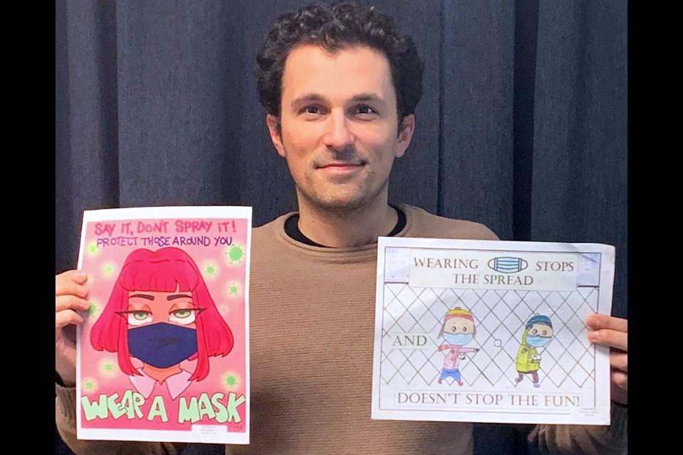 Burnaby Teachers’ Association president Daniel Tetrault poses with a couple winning entries in a recent pro-masking poster contest the local teachers’ union put on recently.