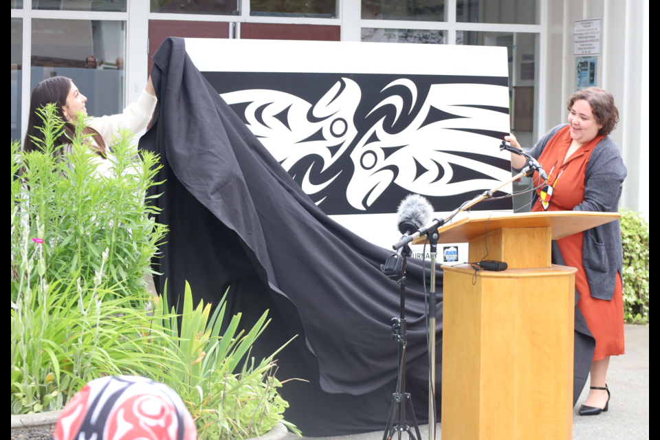 Grade 7 Westridge Elementary student Raven Rocha and Indigenous education programmer at the Burnaby Village Museum Nicole Preissl unveil the design for Burnaby's first reconciliation crosswalk, designed by Atheana Picha.