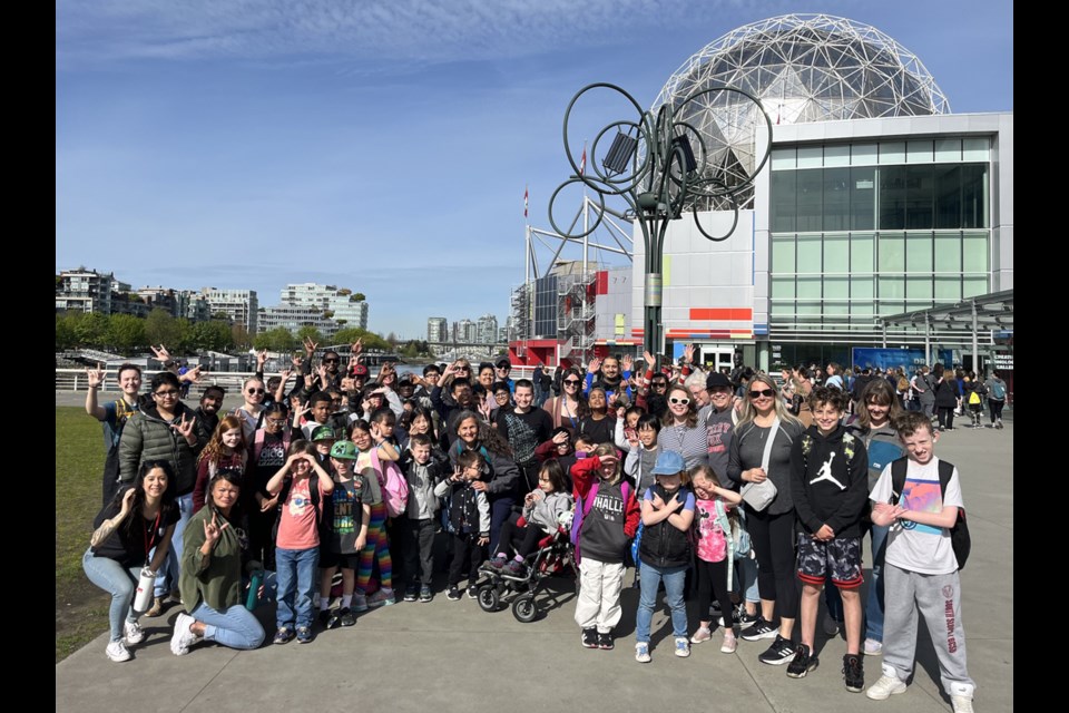 Elementary students pose for a photo outside Science World on friendship day during DHHproud.