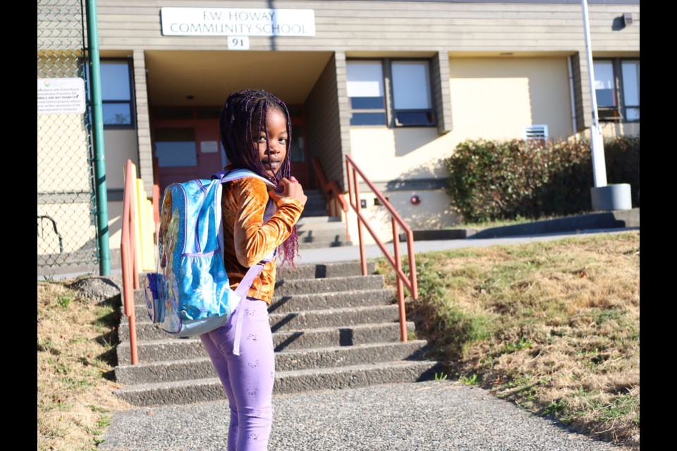 F. W. Howay Community School Grade 1 student, Avielle, shows off her backpack as she prepares to head back to school.