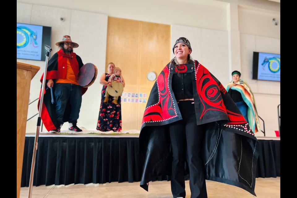 At the Qayqayt Honouring and Rite of Passage Ceremony at NWSS, a graduate was gifted a button blanket that had been made by her Haida family members, and she was guided through a ceremonial dance as family drummed and sang. 
