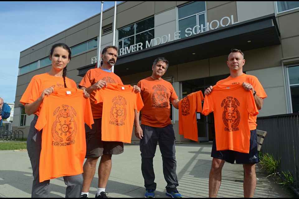 Principal Jen Harrison, teacher Christian Gibson, aboriginal support worker Lee Laufer and vice-principal Gary Pattern model the orange shirts featuring a winning design by Fraser River Middle School student Nicola Garcia.