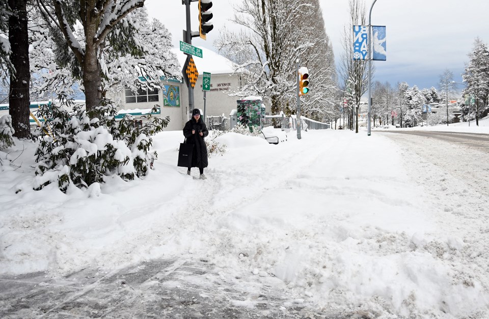 Snow on the sidewalk outside Stride Avenue Community School on Griffiths Drive remained unshovelled Tuesday morning.