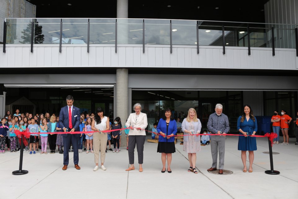 SD40 superintendent Karim Hachlaf, school board chair Gurveen Dhaliwal, Education Minister Jennifer Whiteside, Qayqayt Chief Rhonda Larrabee, principal Kathleen Chad, vice-principal Darren Elves and PAC chair Jen Knight prepare to cut the ribbon to mark the official opening of the new Skwo:wech Elementary School.